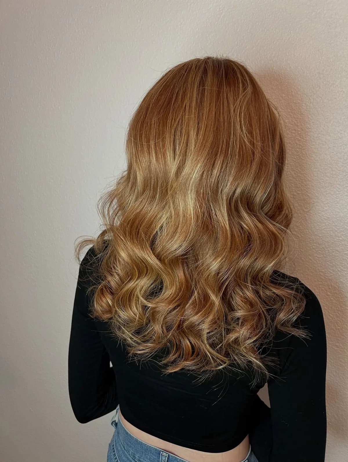 Finished copper balayage with softly curled lengths, viewed from behind