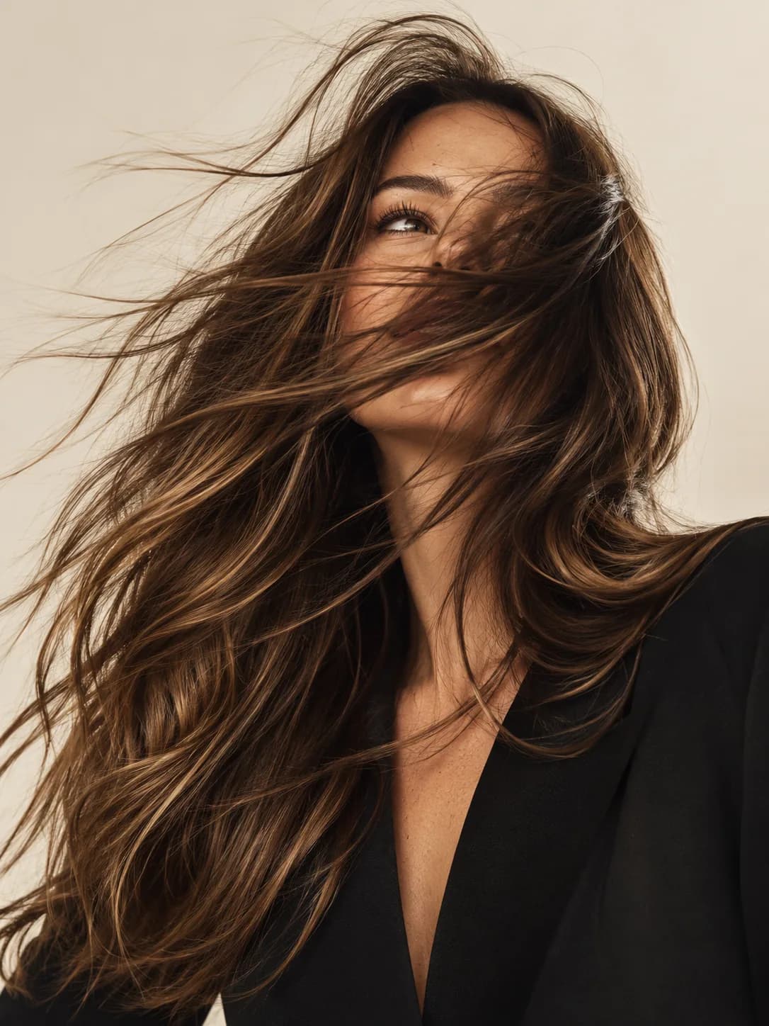Brunette model with long voluminous hair in a studio portrait