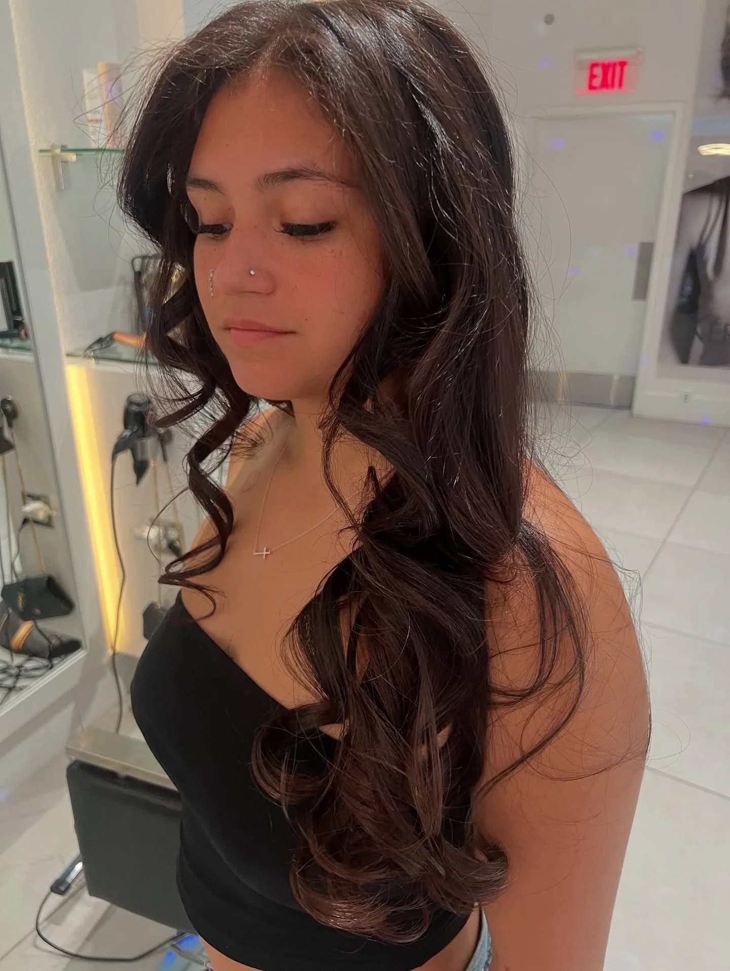 Finished long brunette haircut with soft face-framing layers and curls
