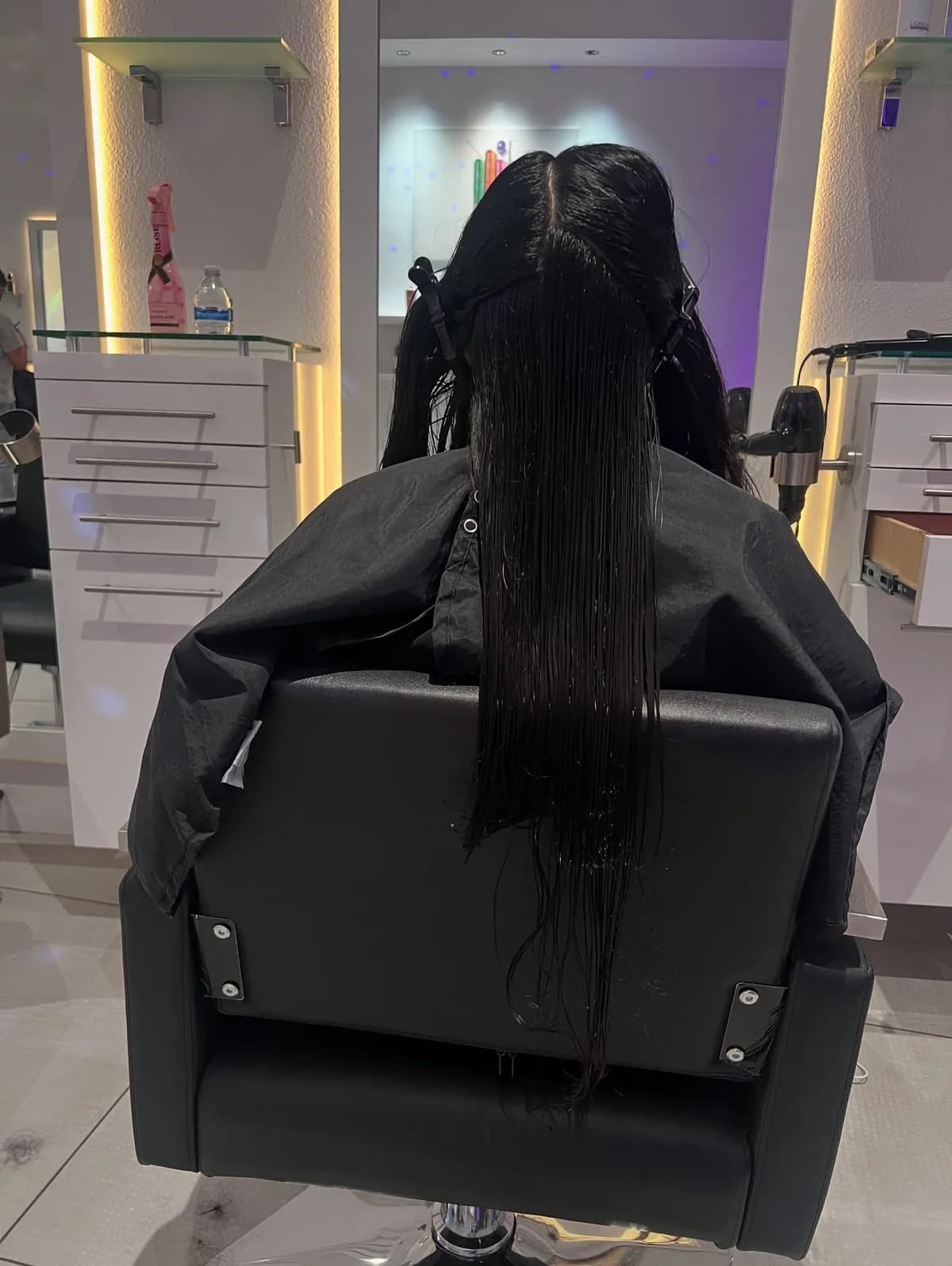 Long wet dark hair sectioned during a treatment in the salon